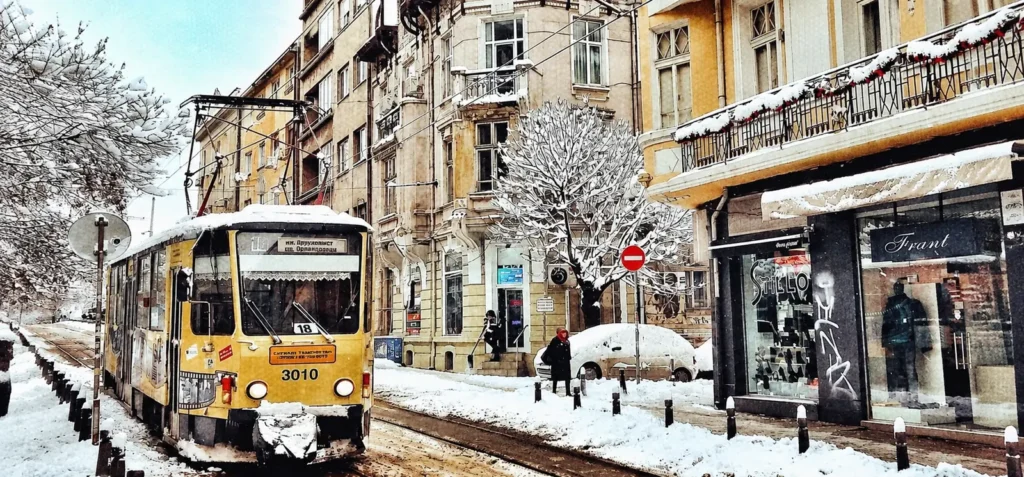 Snowy Sofia street with a yellow tram
